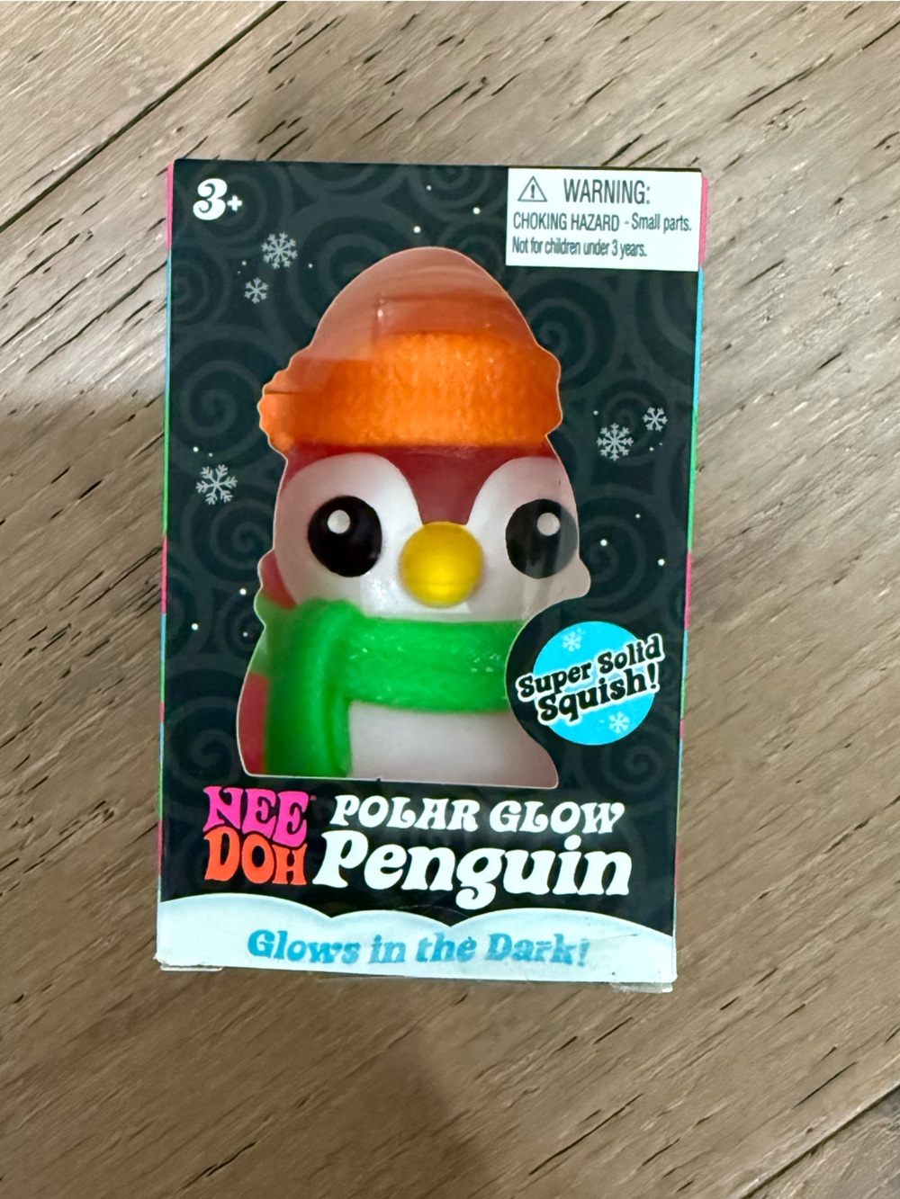 NeeDoh Polar Glow Penguin - Green scarf & Orange hat